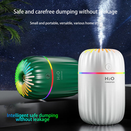 Two humidifiers, one green and one white, with colorful lights on a dark background.