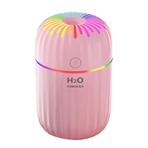Pink humidifier with colorful top on a white background