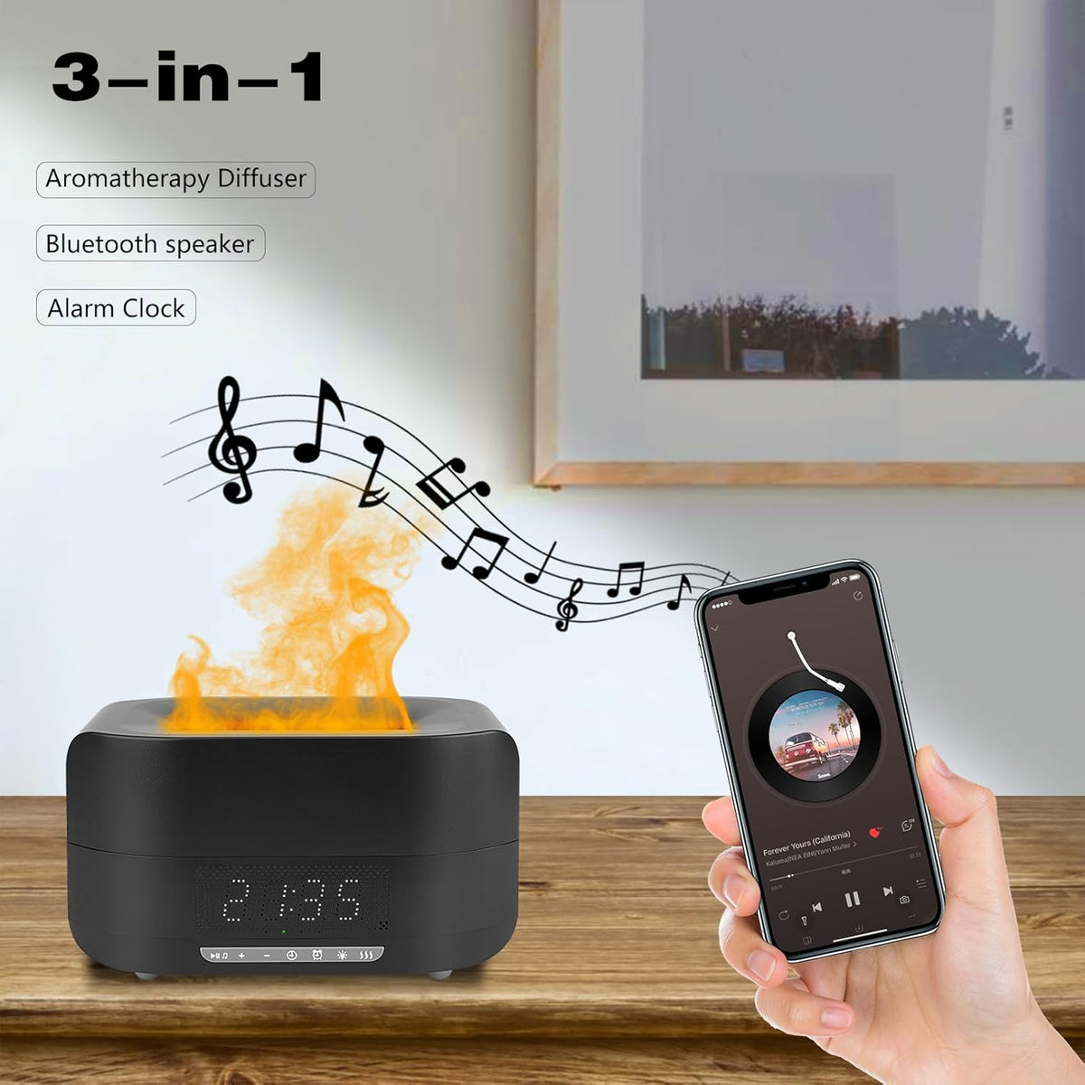 3-in-1 aromatherapy diffuser with Bluetooth speaker and alarm clock on a wooden surface, with a hand holding a smartphone. Emiravaly