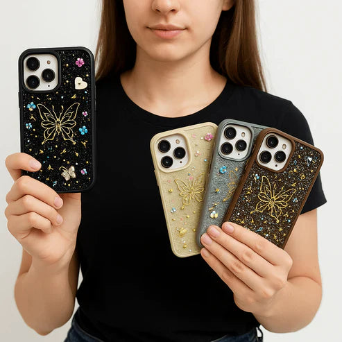 Person holding four ornate phone cases with butterfly designs.