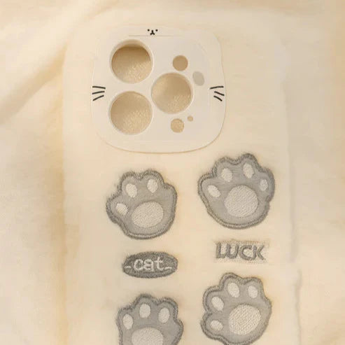 Phone case with paw print designs and text on a beige background