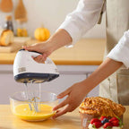 Person using a hand mixer to beat eggs in a bowl on a kitchen counter. Emiravaly uae