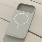 Gray phone case with a circular design on a wooden surface
