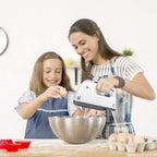 Woman and child baking together using a hand mixer in a kitchen. Emiravaly uae