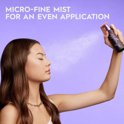Woman using a spray bottle with text about micro-fine mist on a purple background Emiravaly