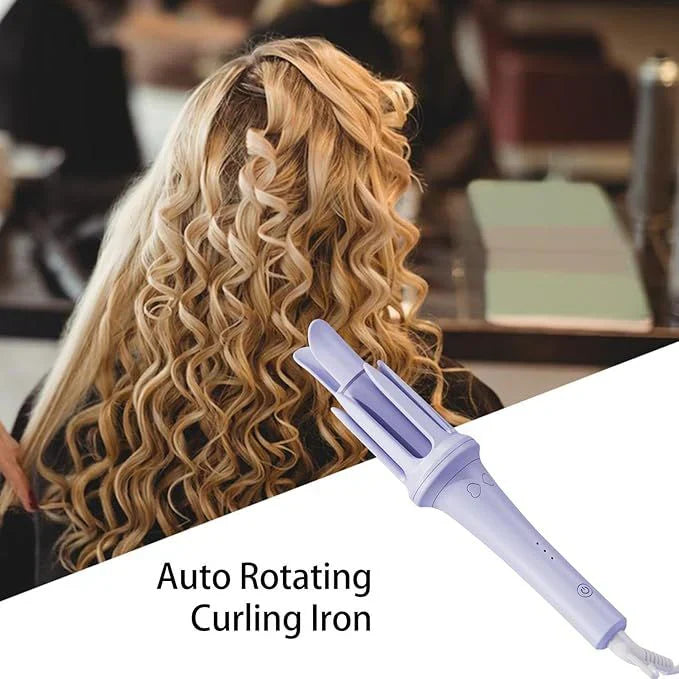 Person with wavy hair using an auto rotating curling iron in a blurred indoor setting